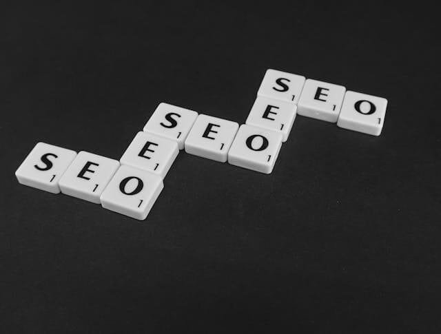 Every Business Needs a Website Image of SEO written blocks